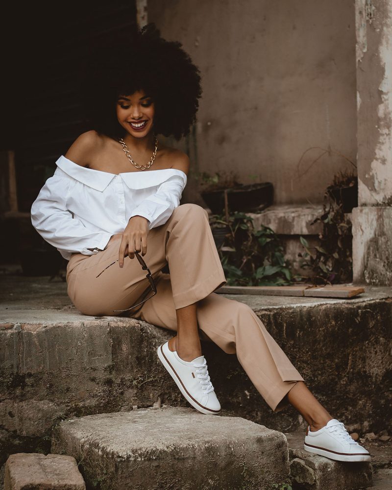 photo-of-smiling-woman-sitting-on-concrete-block-posing-2873674