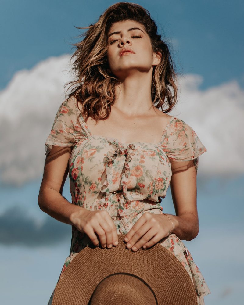 photo-of-woman-in-floral-dress-holding-a-sun-hat-and-posing-3034889