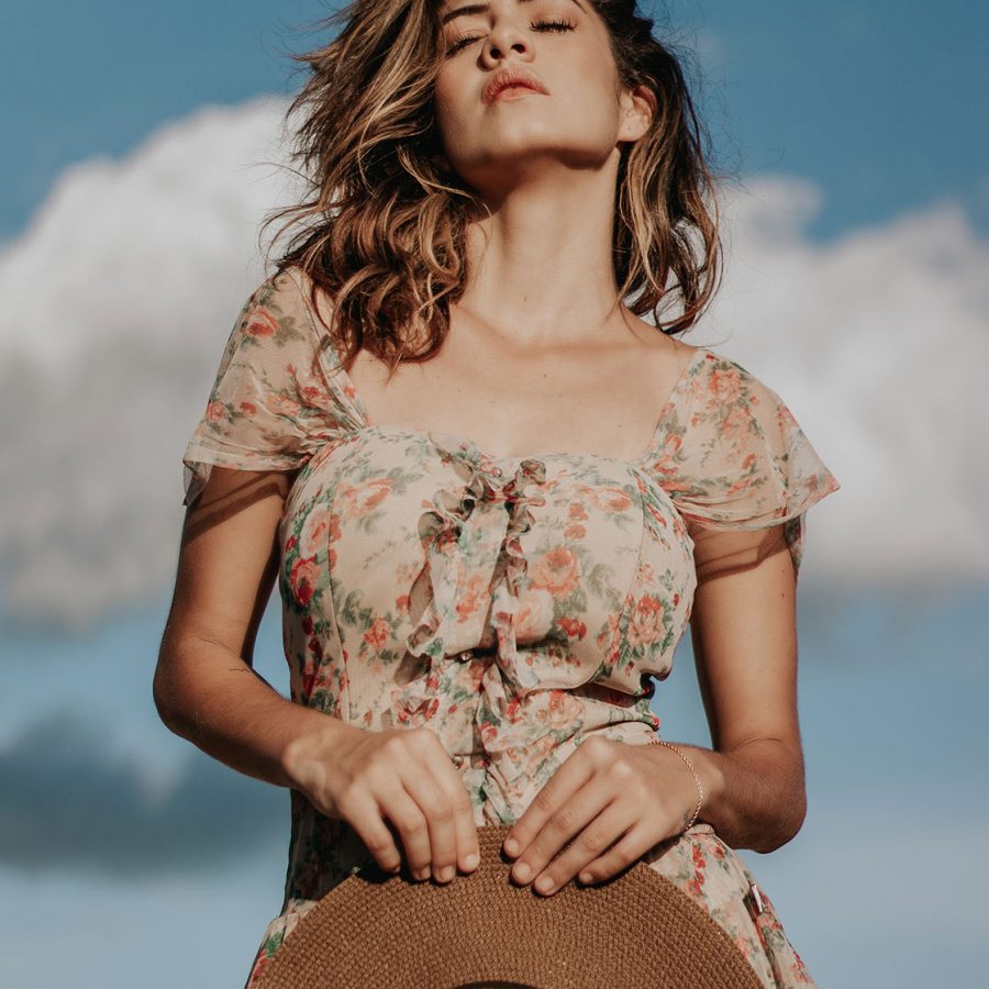 photo-of-woman-in-floral-dress-holding-a-sun-hat-and-posing-3034889